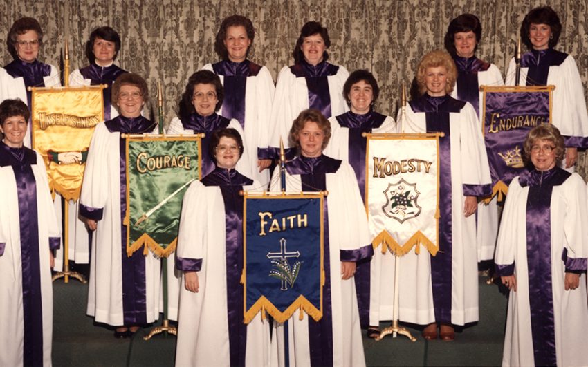 Gowned chapter members with the five graces flags