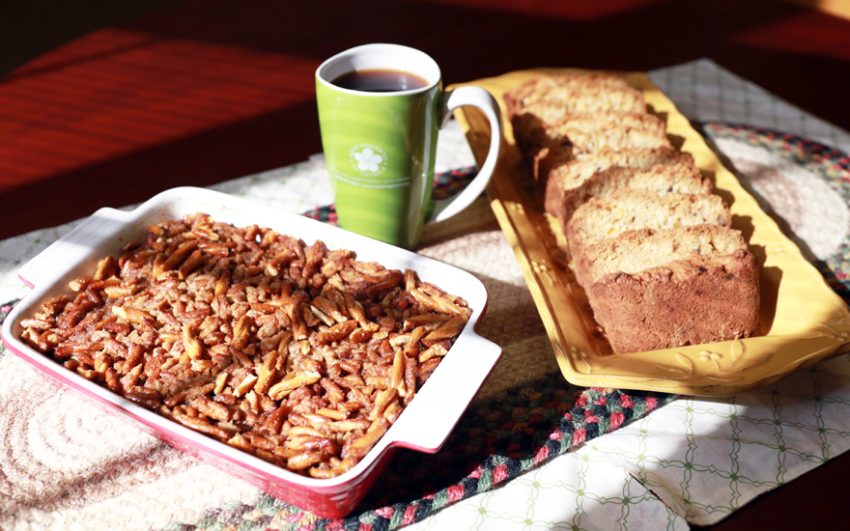 Baked apple crunch in a casserole dish with apple bread and coffee in your favorite mug