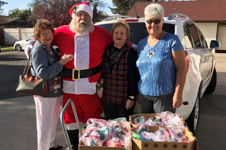 Chapter members hugging Santa