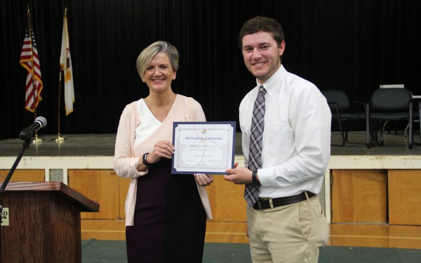 Happy scholarship recipient receiving an award