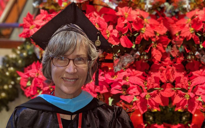 Member Trish Stevens wearing her cap and gown