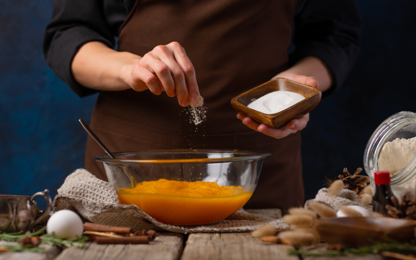 A cook putting a pinch of salt in the recipe.