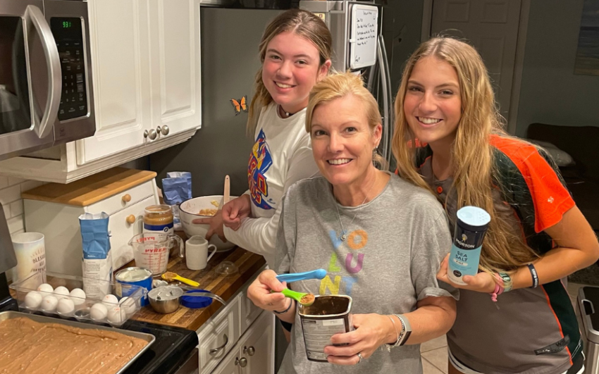 Member Kadi Tubbs making brownies with her two daughters.