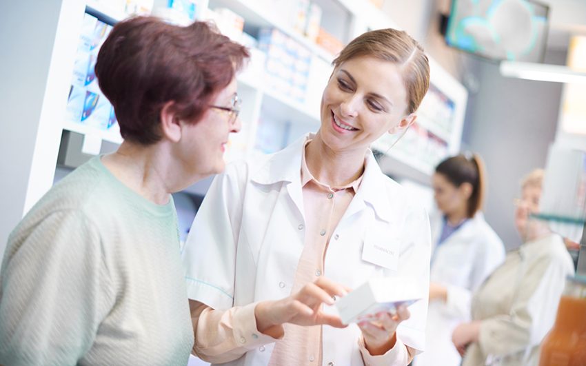 A woman receiving assistance from a pharmacist.