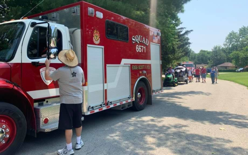 A neighborhood 4th of July parade led by a firetruck.