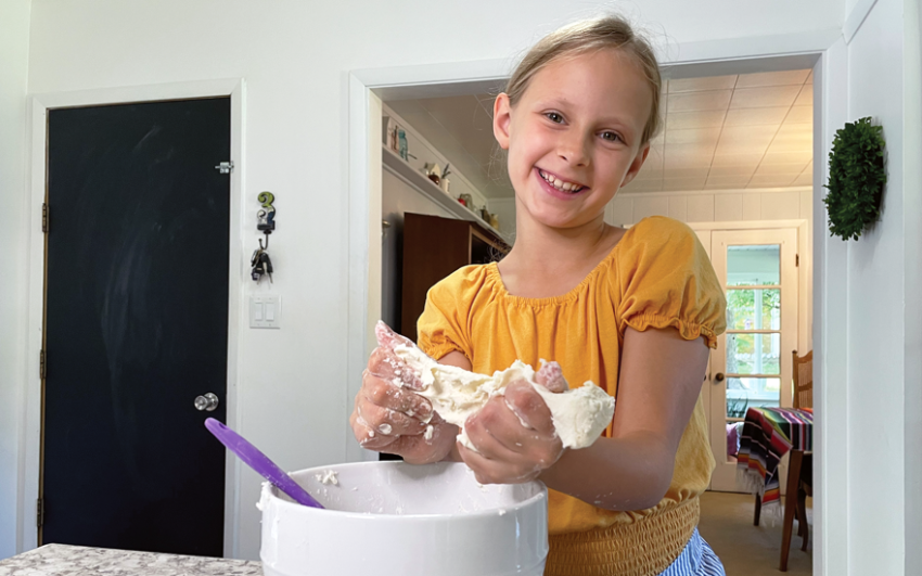 Whipping up a batch of cloud dough while Mom makes dinner.