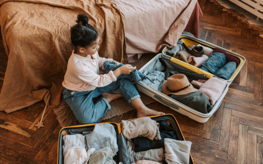 Little girl packing for vacation